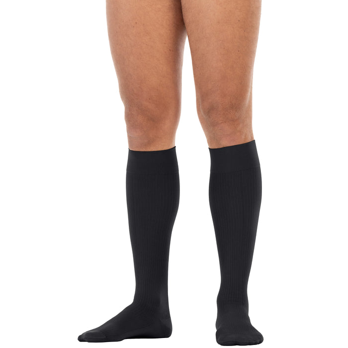 Black knee-high socks worn by a person on a white background