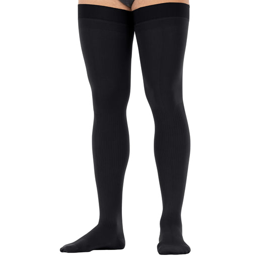 Black thigh high compression worn by a person on a white background