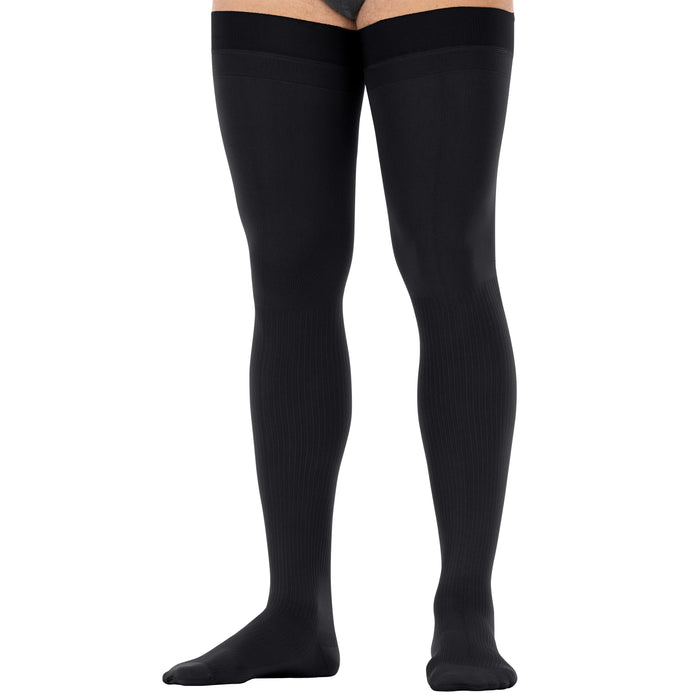 Black thigh high compression worn by a person on a white background